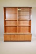 A G-Plan teak modular display cabinet in four sections, the upper glazed and open shelves, the lower