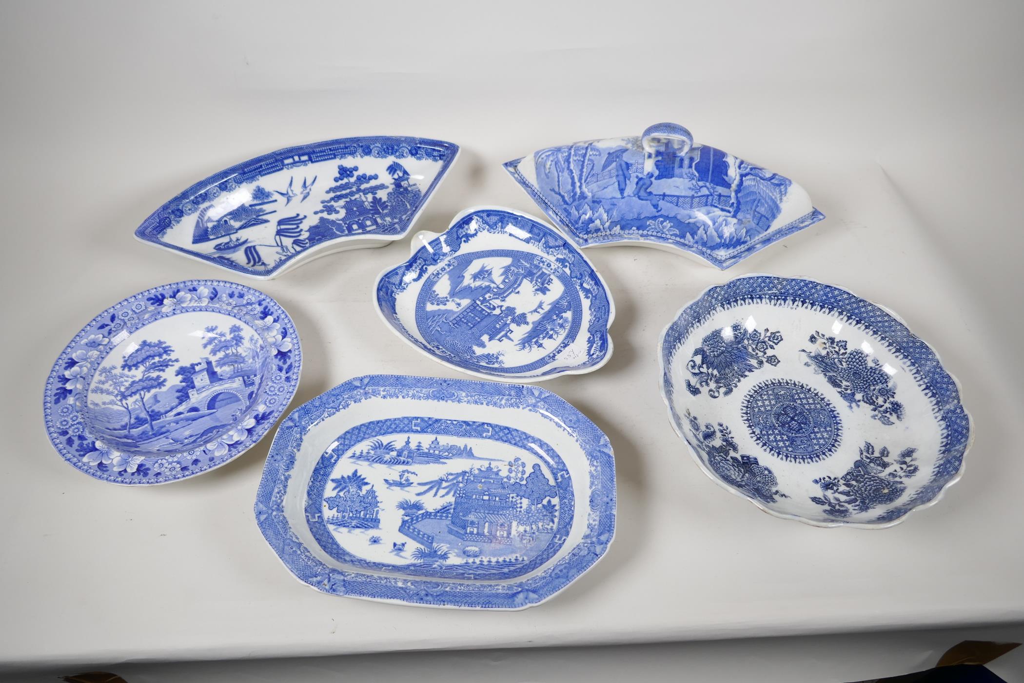 A quantity of C19th blue and white pottery to include a crescent shaped tureen, 13" wide, a petal