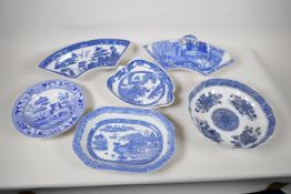A quantity of C19th blue and white pottery to include a crescent shaped tureen, 13" wide, a petal