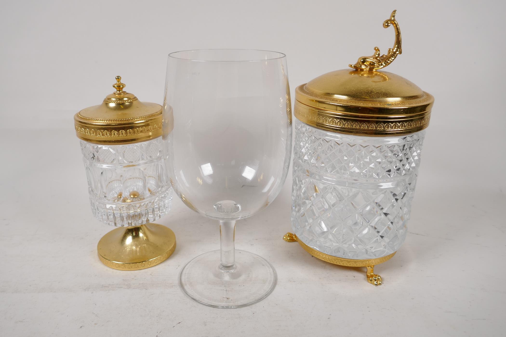 An Italian cut glass and gilt metal biscuit barrel, the cover with dolphin handle, 9" high, a