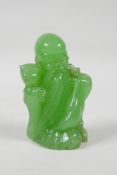 A Chinese apple green glass figure of Shao Lao, 3½" high