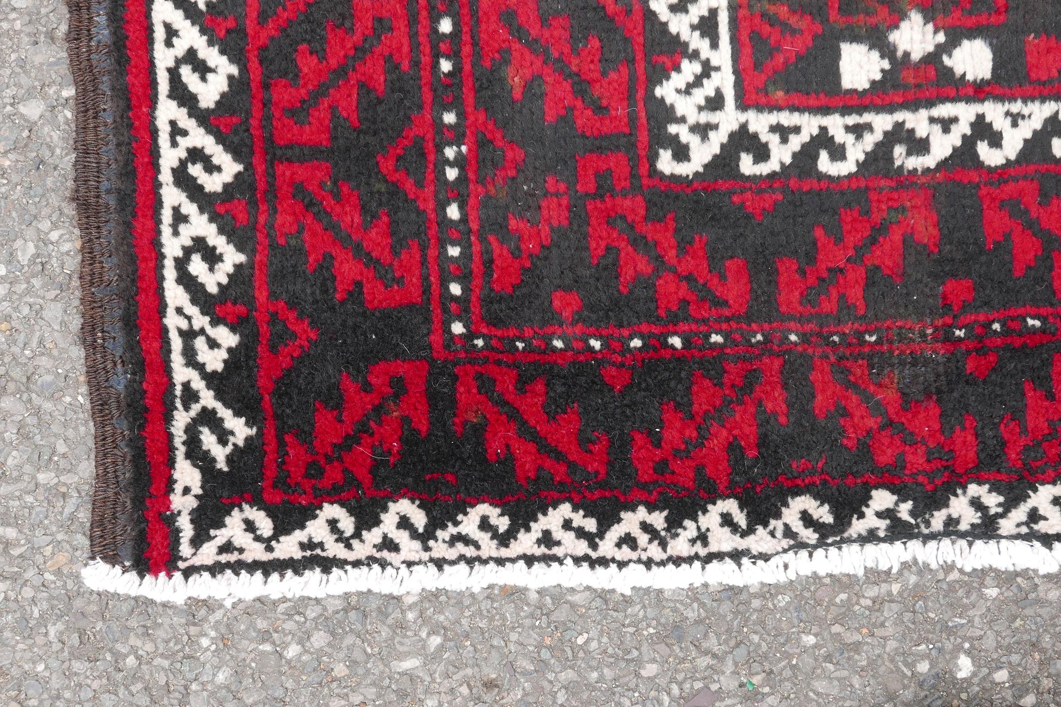 Hand woven full pile red and black ground Iranian Belouch rug, 50½" x 110" - Image 4 of 5