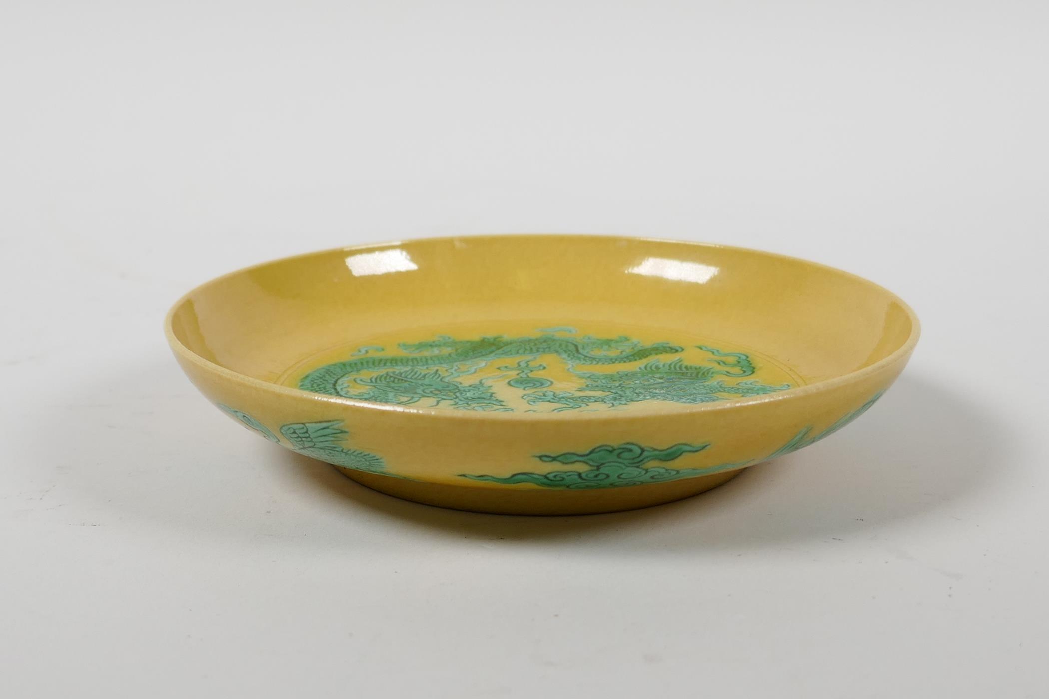 A Chinese yellow ground porcelain saucer decorated with green incised dragons, six character mark to - Image 2 of 4