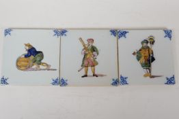 A set of three continental tin glazed tiles with decoration in bright enamels of a musician,