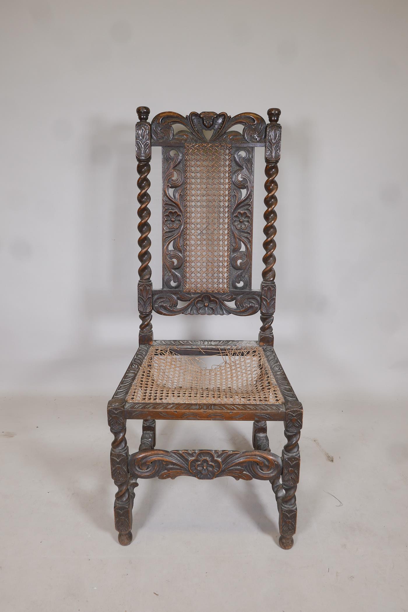 A late C18th/early C19th oak barleytwist chair with a cane seat and back, and carved floral details, - Image 2 of 4