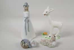 Three Lladro porcelain figurines, Duck with a basket of chicks and two sleeping babies, a Spanish