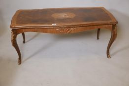 A Rococo style walnut and mahogany veneered coffee table on cabriole supports with ormolu mounts,