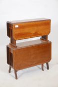 An Edwardian mahogany two tier drop leaf occasional table, with satinwood banded tops, raised on