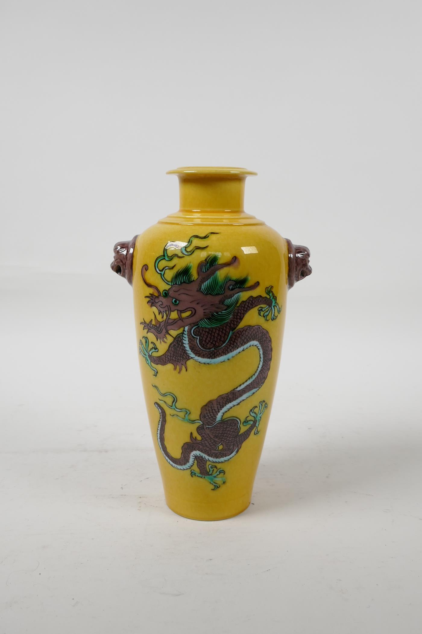 A Chinese Sancai glazed porcelain vase with two lion mask handles and dragon decoration, six