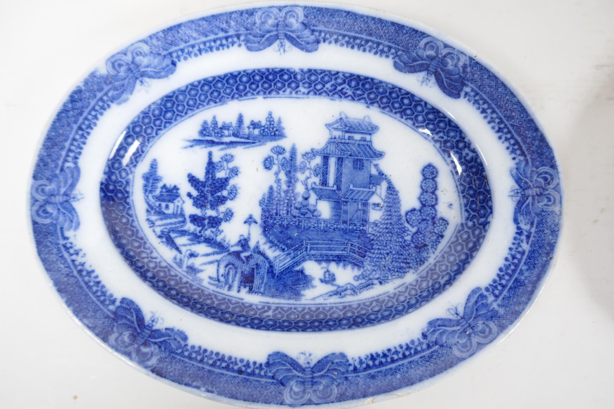 Eight C19th blue and white pottery dishes, various patterns to include the Long Bridge, Boy on a - Image 3 of 7