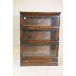 A Globe Wernicke oak three section bookcase, 34" x 12", 47½" high