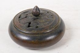 A bronze censer with pierced cover, 4" diameter