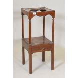 A Georgian mahogany two tier washstand with a single drawer, the upper section on turned column