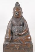 A Sino Tibetan bronze figure of a deity seated in meditation, 11½" high