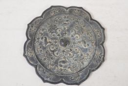 A Chinese Tang style bronze mirror, the back cast with birds and flowers, 8" diameter