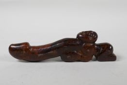 An oriental carved hardstone phallic ornament, 8" long