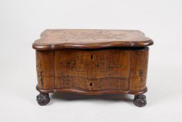 A marquetry inlaid walnut serpentine box on carved ball and claw feet, with a single drawer, 13" x