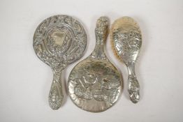 A C19th silver plated dressing table mirror and hairbrush embossed with the five cherubs design, 11"