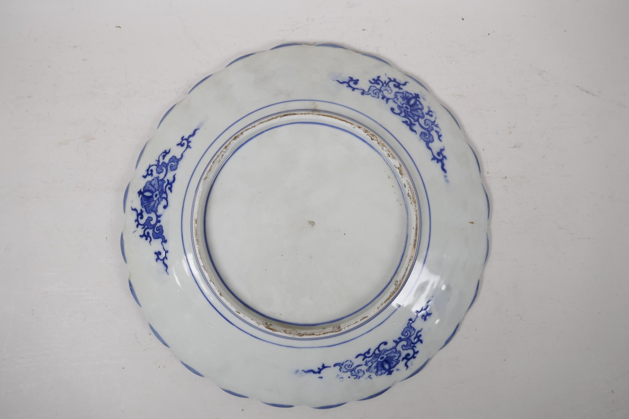 A Japanese blue and white charger with petal shaped edge, decorated with asiatic birds in prunus - Image 3 of 3