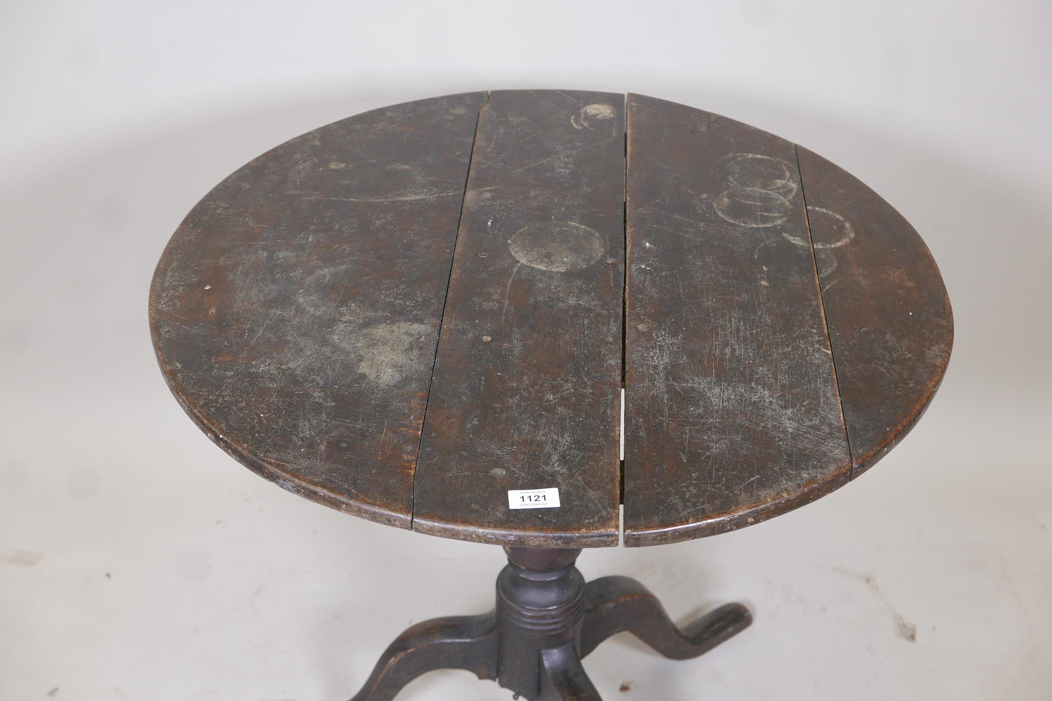 An C18th oak tilt top table raised on a turned column and tripod supports, (top fixed), 30" diameter - Image 2 of 4