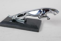 A chrome plated Jaguar car mascot paper weight, on a hard stone base 8" long