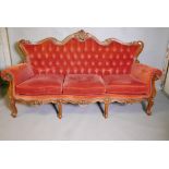 A Victorian style three piece show wood parlour suite, comprising a shaped button back three