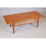 A Danish mid century Trioh teak coffee table with cane undertier, 47" x 20" x 16"