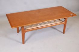 A Danish mid century Trioh teak coffee table with cane undertier, 47" x 20" x 16"