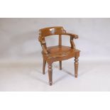 A stained beechwood bow back desk chair with studded faux leather seat, raised on turned supports,