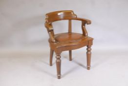 A stained beechwood bow back desk chair with studded faux leather seat, raised on turned supports,