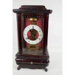 A cased skeleton clock with white enamel chapter ring and Roman numerals, 15" high