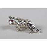 A miniature sterling silver figure of a fox with ruby set eyes, 1½" long