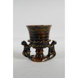 An English treacle glazed earthenware cup/goblet, with two handles in the form of leopards, marks to