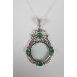 A 925 silver magnifying glass pendant, set with 4 green semi-precious stones, 3" drop