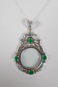 A 925 silver magnifying glass pendant, set with 4 green semi-precious stones, 3" drop