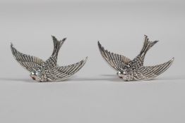 A pair of sterling silver cufflinks in the form of swallows with ruby set eyes, 1½" wide