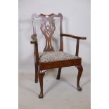 A Georgian Chippendale style walnut elbow chair, with pierced splat back scroll arms and drop in