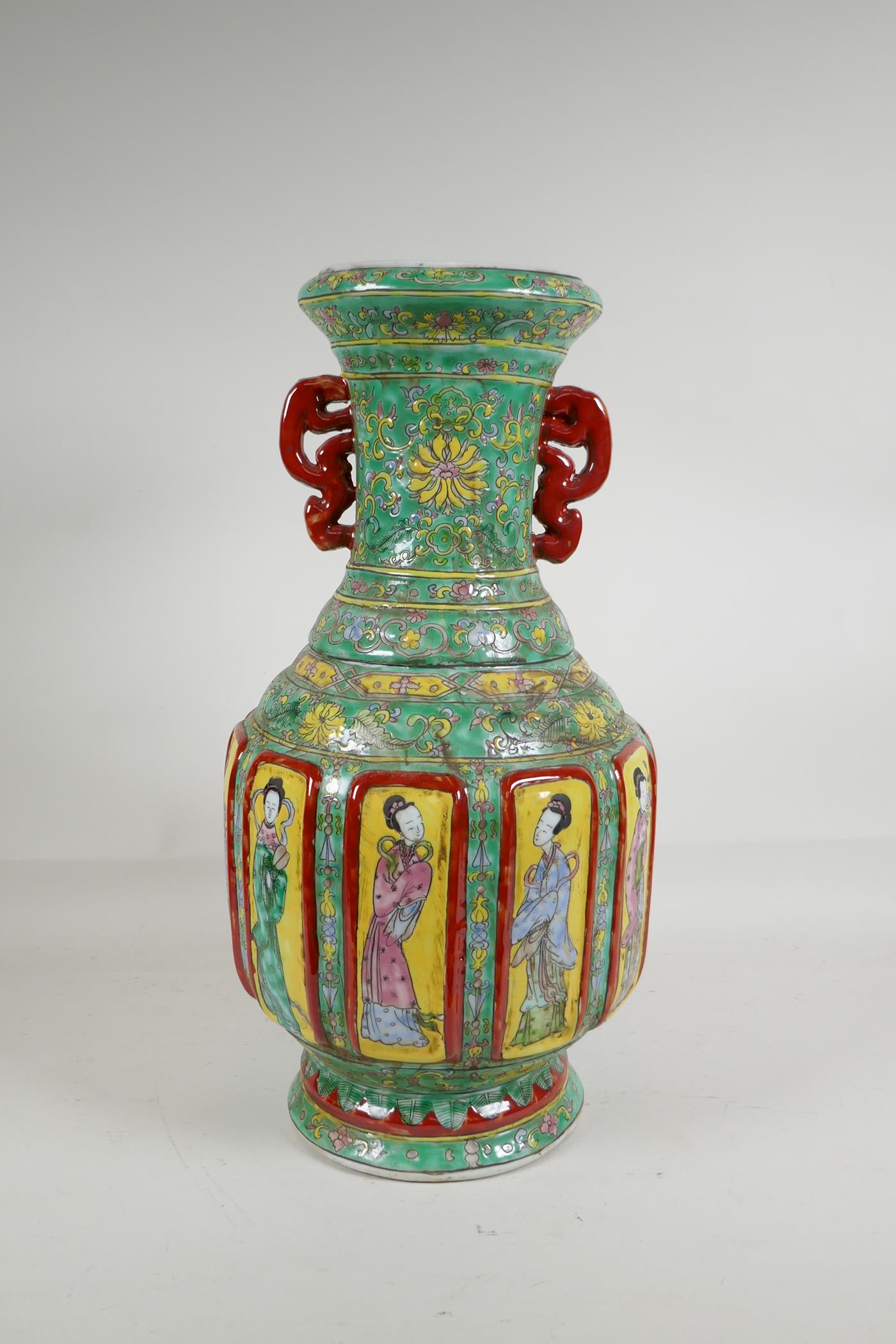 A Chinese polychrome porcelain two handled vase with raised decorative enamelled panels, depicting