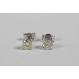 A pair of 14ct white gold diamond stud earrings, 50 points total