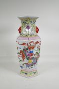 A Chinese polychrome porcelain hexagonal shaped vase, with two mask handles, decorated with warriors