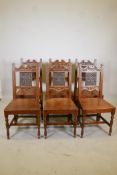 A set of six oak dining chairs with carved backs