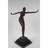 A bronze figurine of a dancer, on a stepped hardstone base, after F. Preiss. 16½" high
