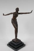 A bronze figurine of a dancer, on a stepped hardstone base, after F. Preiss. 16½" high