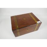 A brass bound mahogany writing slope, with brass cartouche and lock plate, 12" x 8½" x 6"