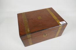 A brass bound mahogany writing slope, with brass cartouche and lock plate, 12" x 8½" x 6"