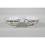 A pair of early C20th Chinese polychrome porcelain tea bowls, with lobed rims and enamel