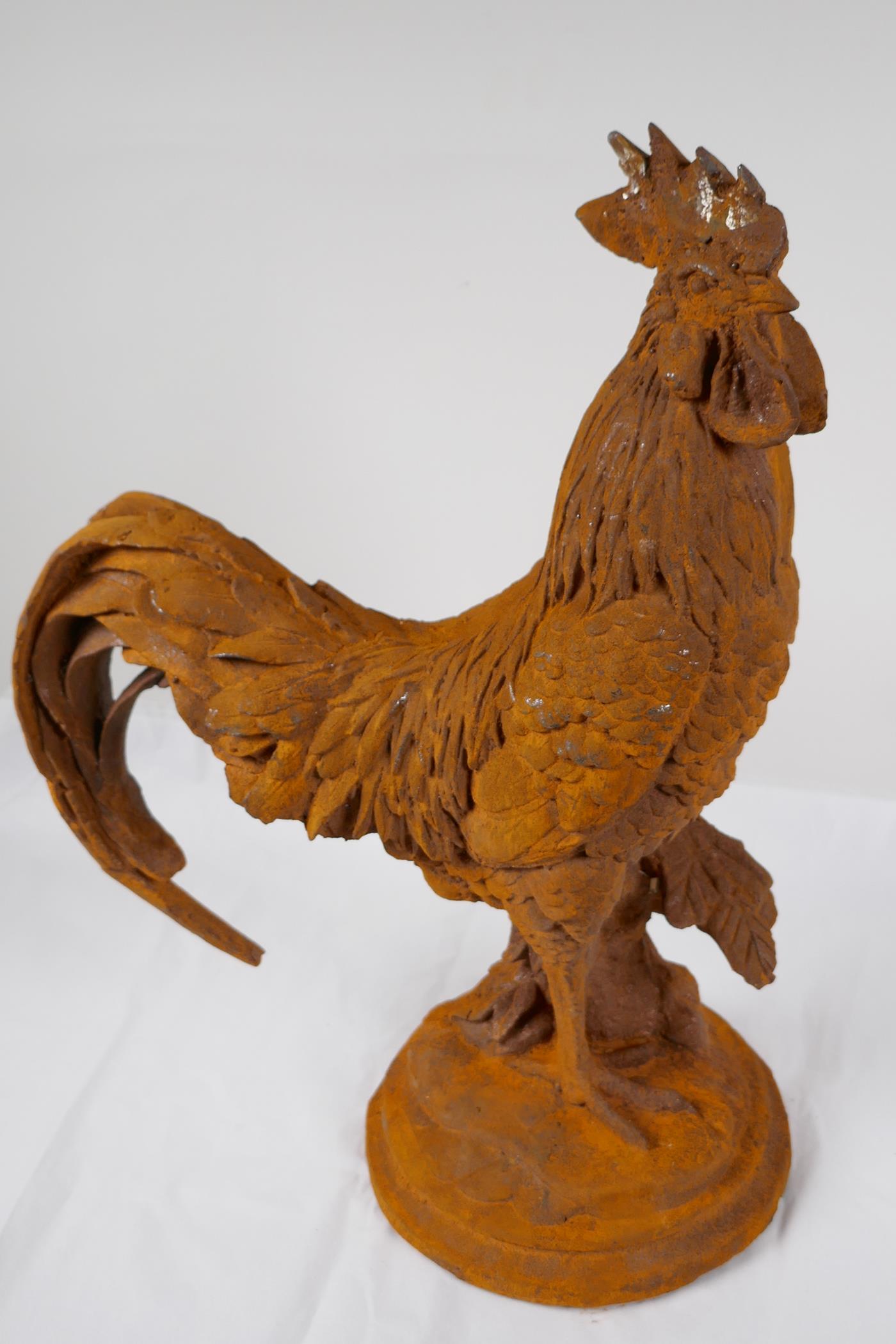 A cast iron garden figure of a cockerel, 17" high