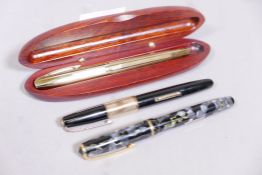 A Watermans vintage gold plated and lacquer fountain pen, a Burnham fountain pen, and a Sheaffer
