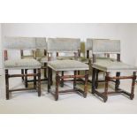 A set of six French dining chairs with upholstered solid backs and seats, raised on turned