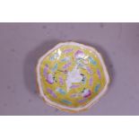 A Chinese Republic ceramic stem bowl with enamel decoration of lotus and birds on a yellow glazed